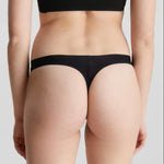 Back view of Calvin Klein Invisibles Thong Black, showing laser-cut edges for a flawless silhouette.