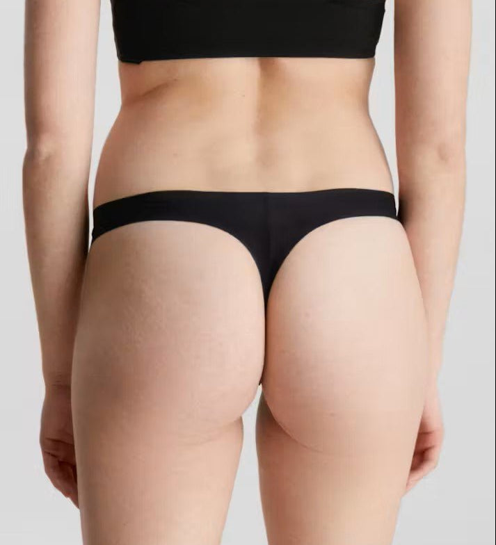 Back view of Calvin Klein Invisibles Thong Black, showing laser-cut edges for a flawless silhouette.