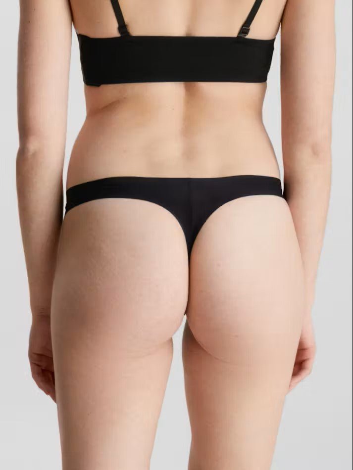 Back view of Calvin Klein Invisibles Thong Black, showing laser-cut edges for a flawless silhouette.