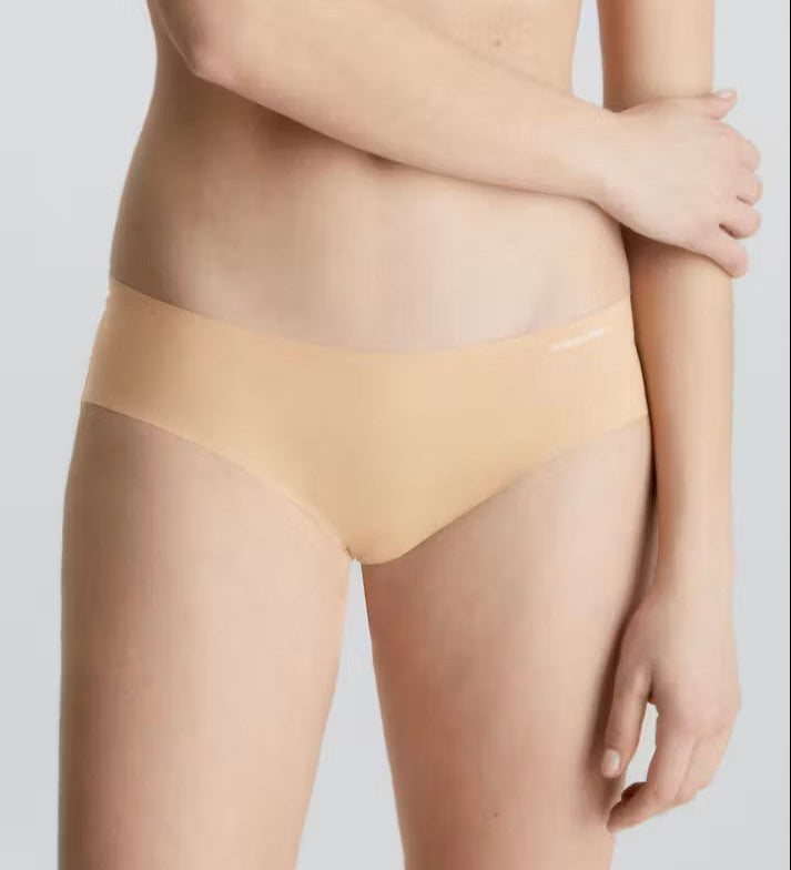 Front view of Calvin Klein Invisibles Hipster Light Caramel, a seamless nude microfibre brief for a smooth, invisible fit.