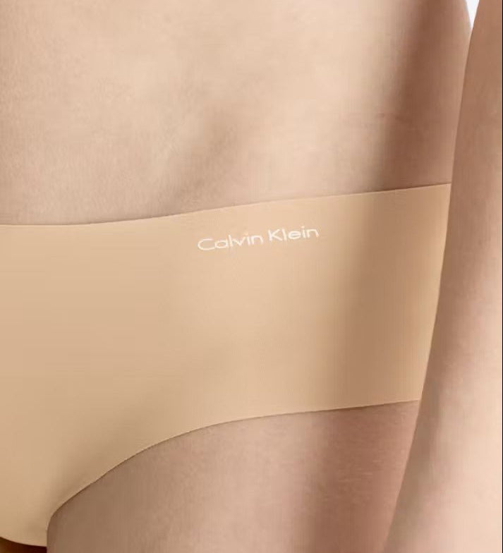 Side view of Calvin Klein Invisibles Hipster Light Caramel, showing soft microfibre fabric and medium rise waist.