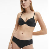 Model wearing Calvin Klein Perfectly Fit T-Shirt Bra Black, a seamless underwire bra with soft moulded cups, adjustable straps, and smooth finish.