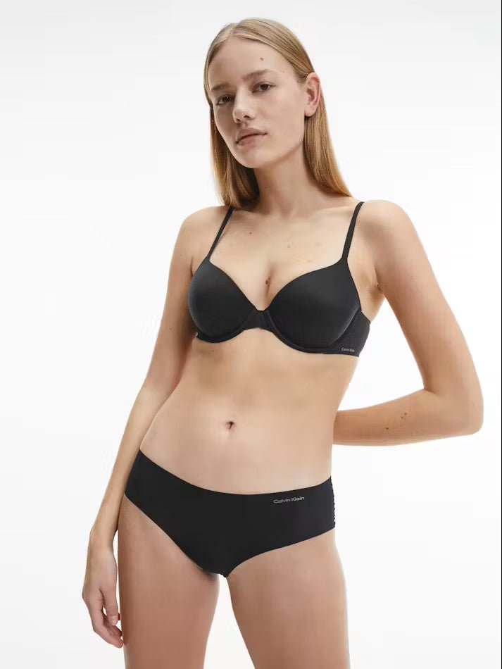 Model wearing Calvin Klein Perfectly Fit T-Shirt Bra Black, a seamless underwire bra with soft moulded cups, adjustable straps, and smooth finish.