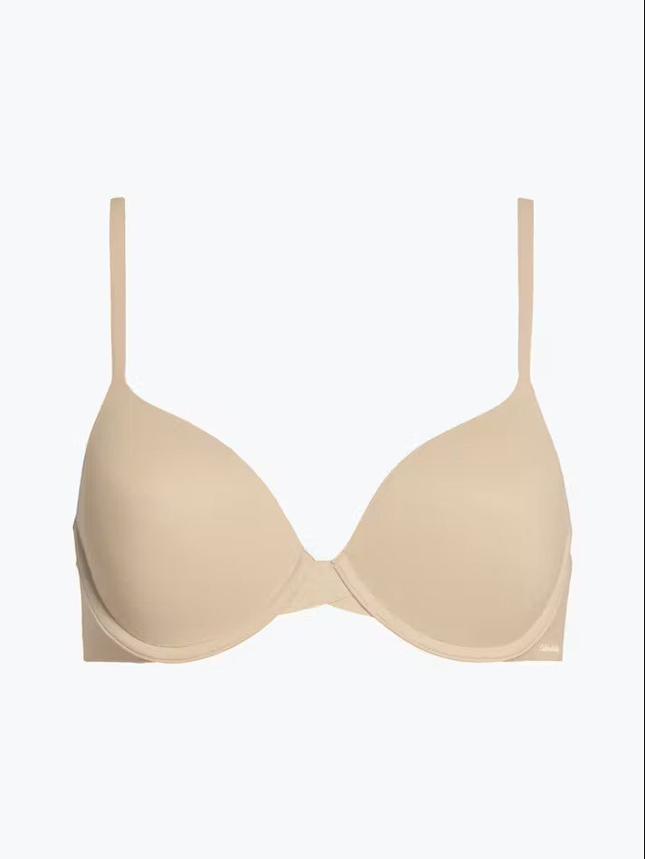 Calvin Klein Perfectly Fit T-Shirt Bra Bare laid flat, highlighting seamless nude microfibre material, moulded cups, and adjustable straps.