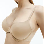 Close-up of Calvin Klein Perfectly Fit T-Shirt Bra Bare in nude, featuring seamless moulded cups, adjustable straps, and underwire support.