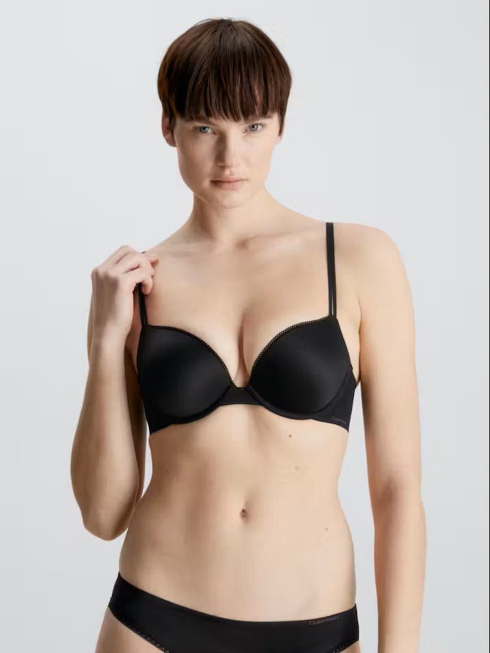 Full front view of Calvin Klein’s Liquid Touch Push Up Plunge Bra in Black—sleek, seamless, and supportive, stocked at The Foundation.