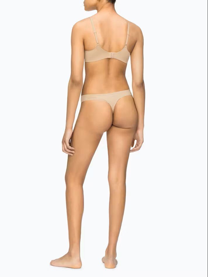 Back view of full-body shot of Calvin Klein's Liquid Touch Push Up Plunge Bra in Bare with matching bottoms—supportive and smooth, from The Foundation.