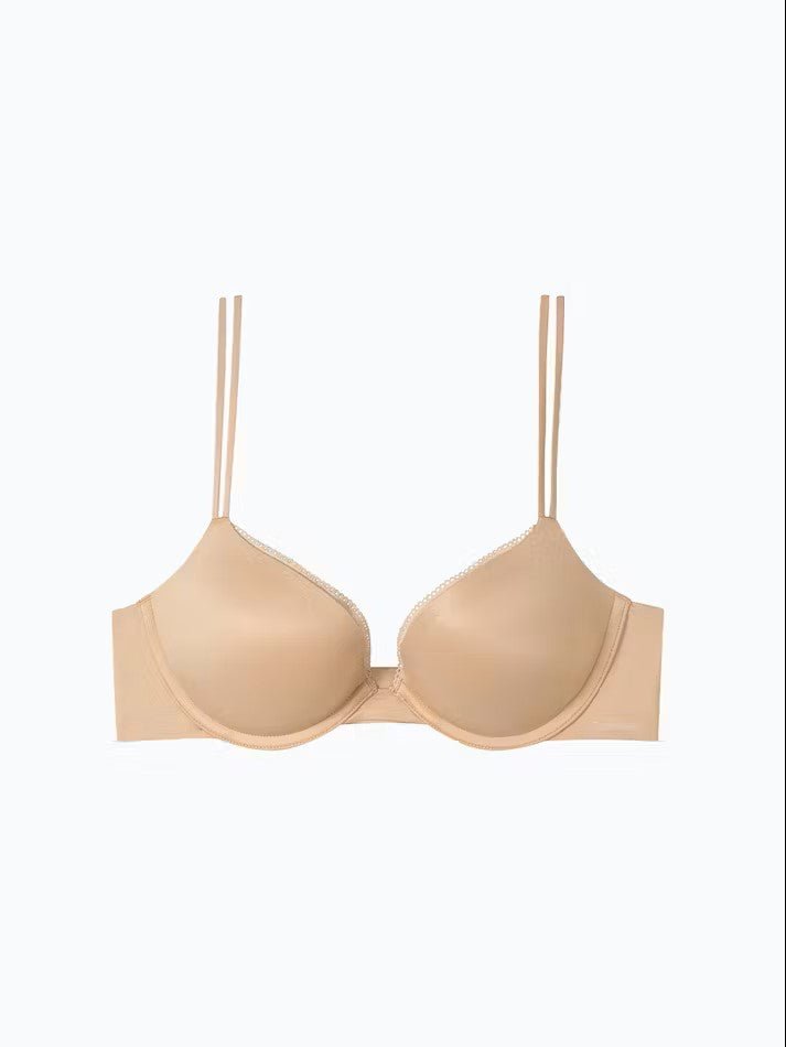 Flat lay of Calvin Klein Liquid Touch Push Up Bra in Bare from The Foundation, showing moulded cups, lace trim, and sleek nude finish.