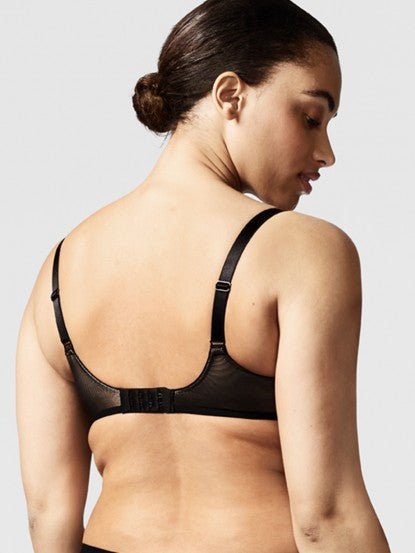 Model wearing the Chantelle Revele Moi 4 Parts Wire Bra in Black, featuring sheer mesh panels, full coverage cups, and supportive underwire design. back view
