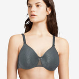 Model wearing the Chantelle C Magnifique Moulded Bra in Slate Grey from The Foundation, featuring full-coverage cups and smoothing back band.