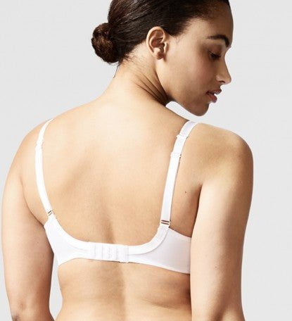 Model wearing Chantelle Parisian Allure Covering Bra in White from The Foundation, featuring semi-sheer cups, plunge neckline, and racerback straps. back view
