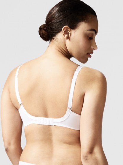 Model wearing Chantelle Parisian Allure Covering Bra in White from The Foundation, featuring semi-sheer cups, plunge neckline, and racerback straps. back view