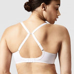 Model wearing Chantelle Parisian Allure Covering Bra in White from The Foundation, featuring semi-sheer cups, plunge neckline, and racerback straps. back view