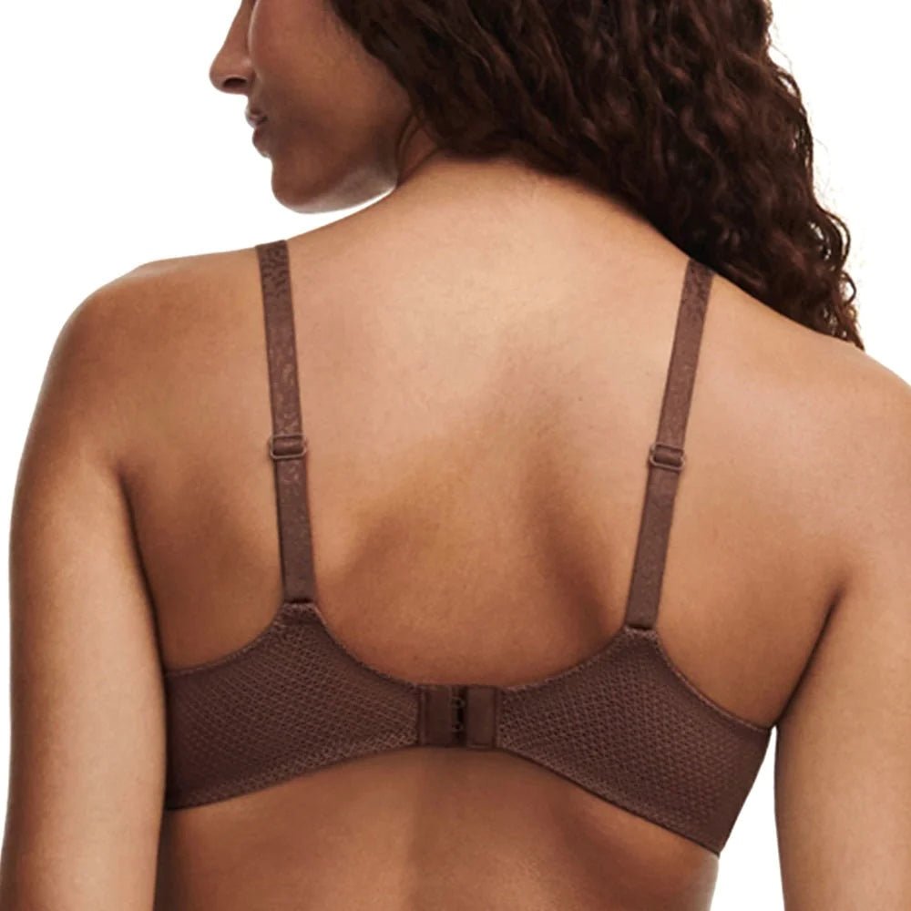 Back view of model in Fleurs Half Cup Balcony Bra Leo Print from The Foundation, featuring fishnet lining and gold ring strap details