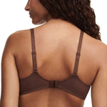Back view of model in Fleurs Half Cup Balcony Bra Leo Print from The Foundation, featuring fishnet lining and gold ring strap details