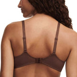 Back view of model in Fleurs Half Cup Balcony Bra Leo Print from The Foundation, featuring fishnet lining and gold ring strap details