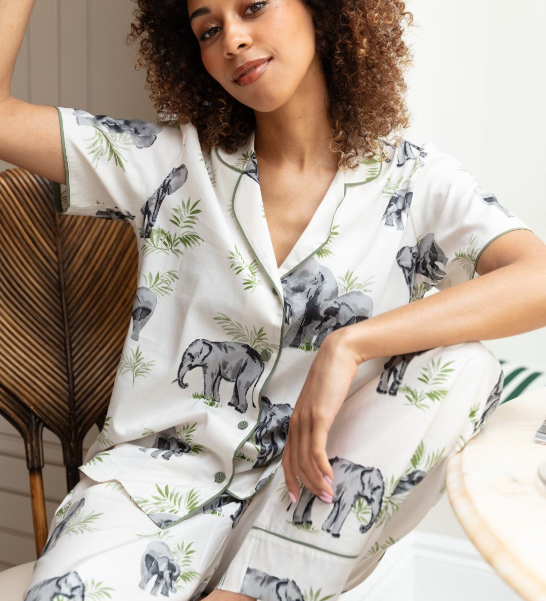 Close-up of the elephant print and sage modal trim on the top, as well as the drawstring detail and fabric texture of the bottoms.