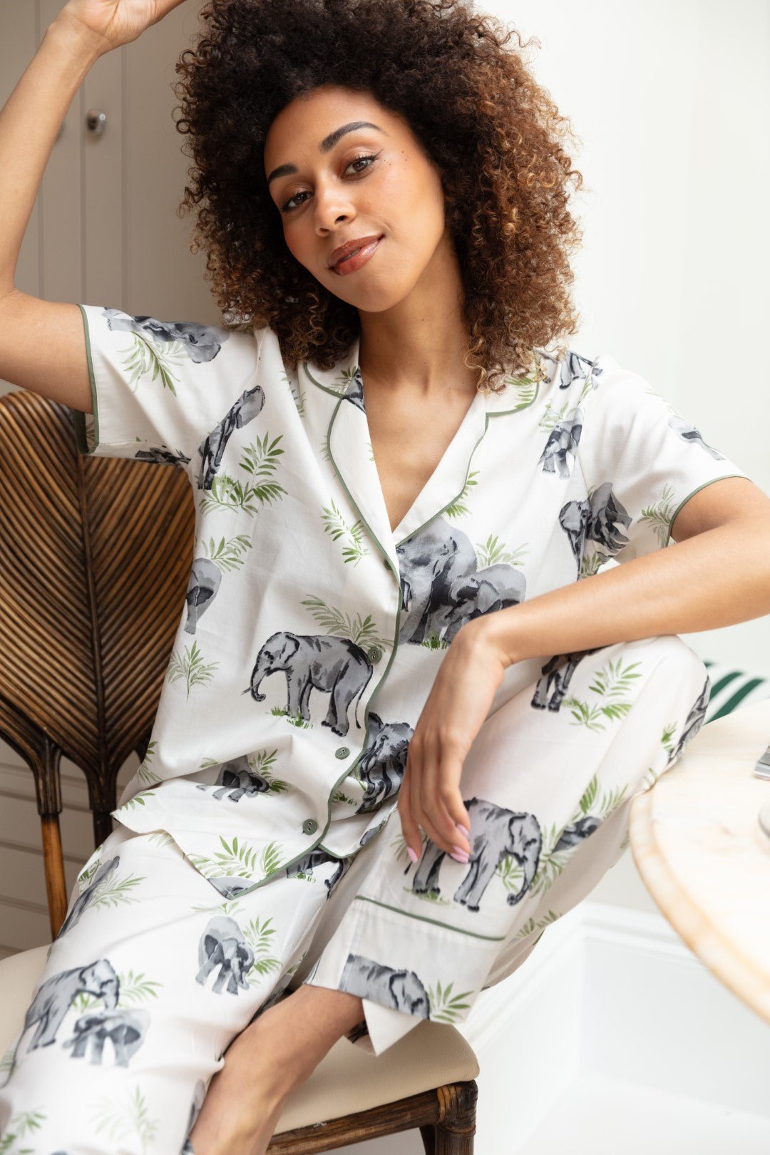 Close-up of the elephant print and sage modal trim on the top, as well as the drawstring detail and fabric texture of the bottoms.
