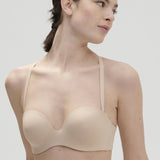 Model wearing Essentiel Multi Strapless Bra Peau Rose, front close-up showing bandeau and moulded cup design.