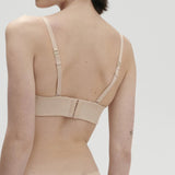 Back view of Essentiel Strapless Bra Peau Rose showing smooth band and convertible straps.