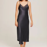 Model wearing Ginia Silk Lace Slip in India Ink, showcasing deep V-neckline and delicate lace trim.