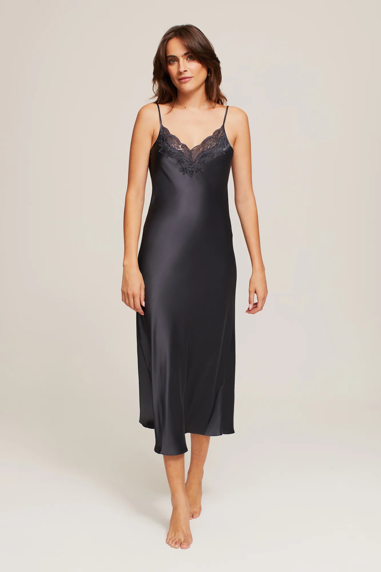 Model wearing Ginia Silk Lace Slip in India Ink, showcasing deep V-neckline and delicate lace trim.