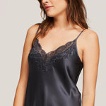 Close-up of navy Ginia silk slip with hand-cut lace detailing and thin adjustable straps.