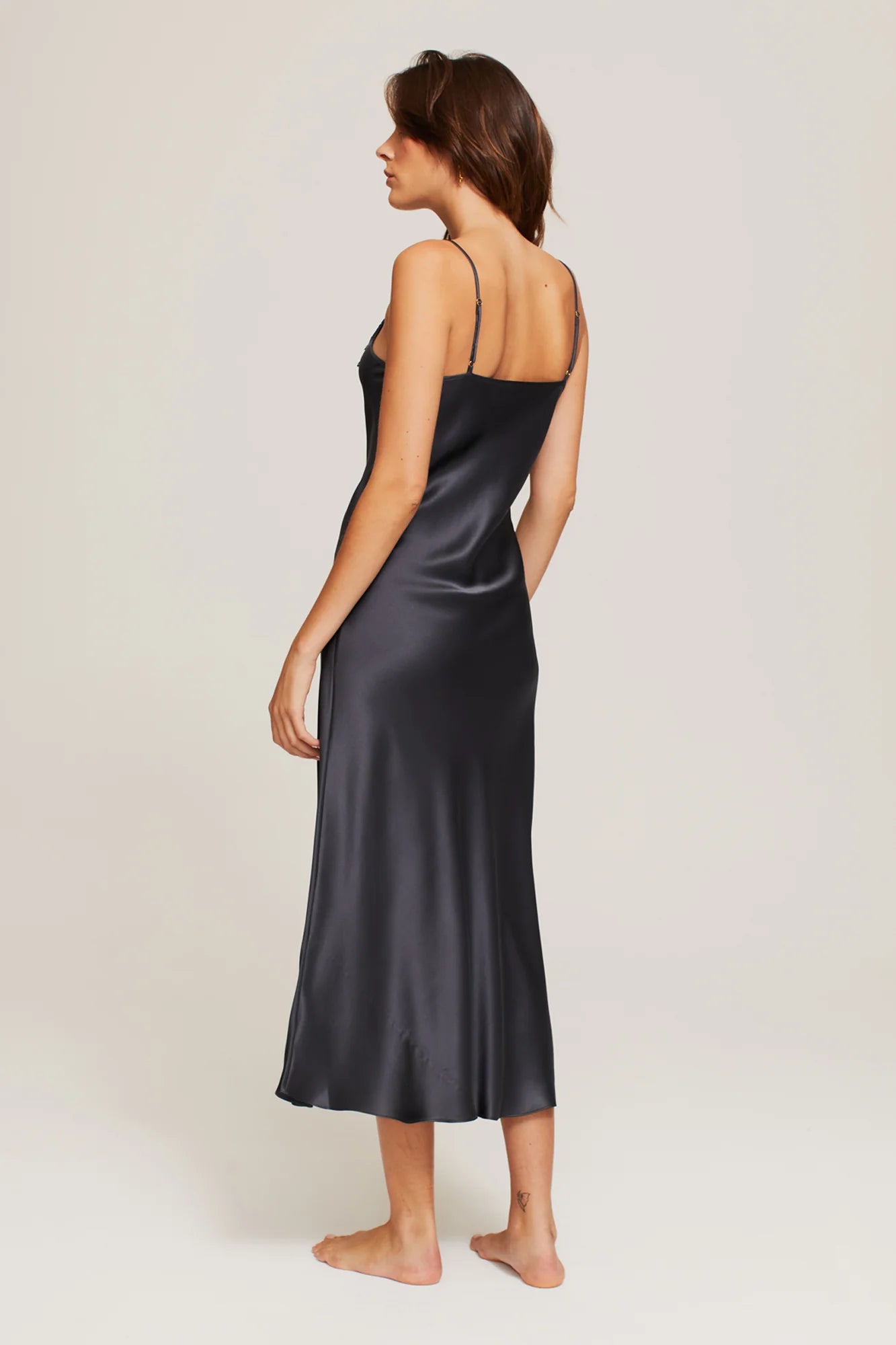 Back view of Ginia Silk Lace Slip in navy, showing bias cut and French seam finish.
