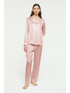Model wearing Ginia Fine Finishes Silk Pyjama in Bridal Rose, showing collared top and drawstring pants.
