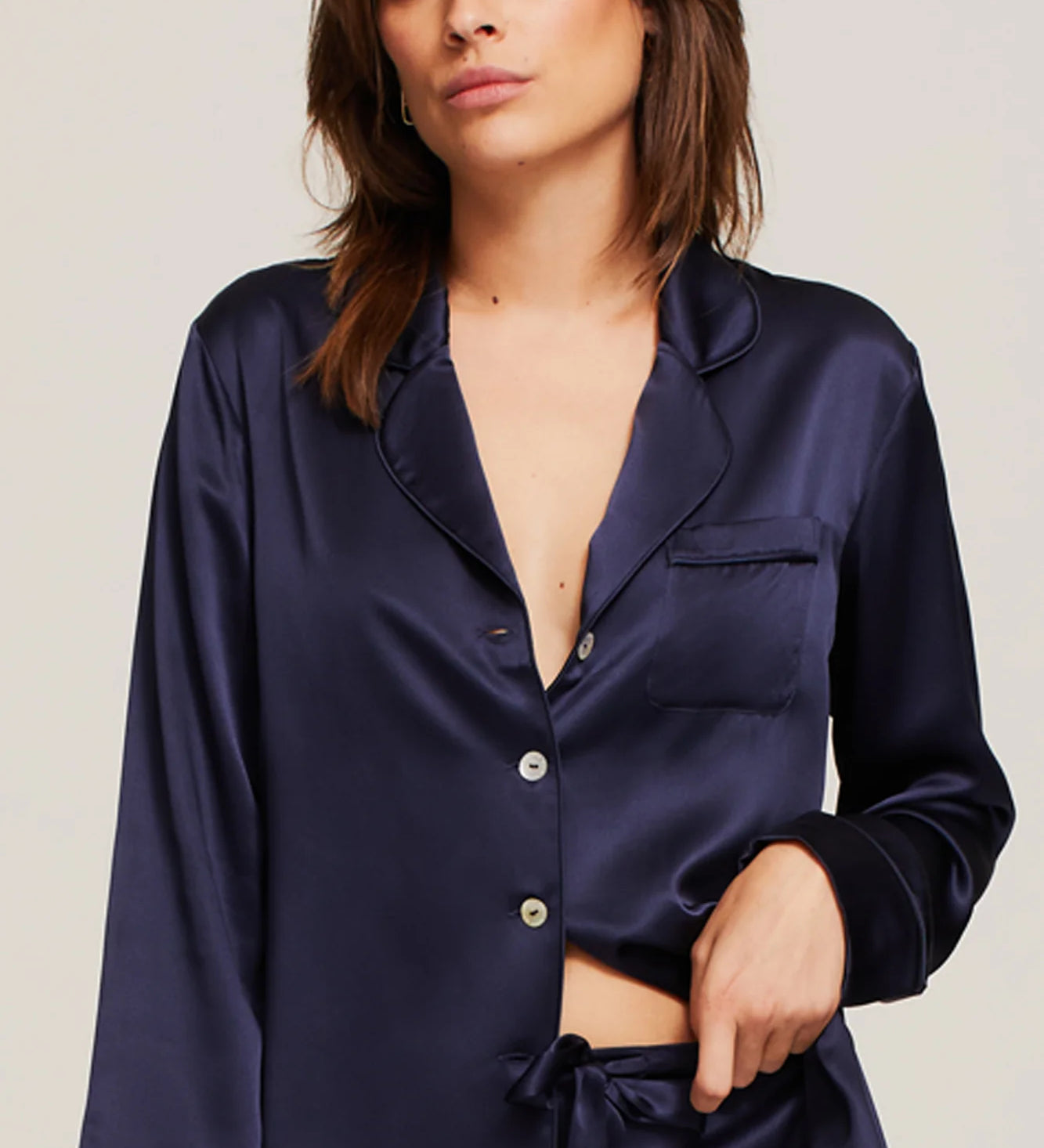 Close up of Model in Ginia Fine Finishes Silk Pyjama Midnight showing collared V neckline and silky texture.