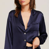 Close up of Model in Ginia Fine Finishes Silk Pyjama Midnight showing collared V neckline and silky texture.