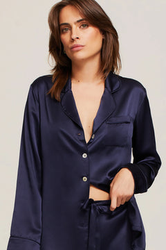 Close up of Model in Ginia Fine Finishes Silk Pyjama Midnight showing collared V neckline and silky texture.
