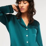 Close-up of Ginia Silk Pyjama Emerald top with pearl buttons and silk piping detail.