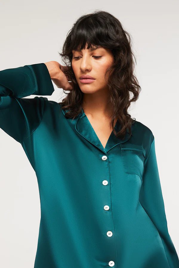 Close-up of Ginia Silk Pyjama Emerald top with pearl buttons and silk piping detail.