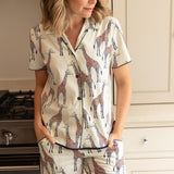 Close-up of the giraffe motif and navy modal trim detailing on the top’s buttons and the pant’s waistband.