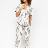 Front view of the Cyberjammies Georgina Giraffe Print Pyjama Set, showcasing the pointed collar top and wide-leg pants with drawstring and pockets