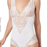 Front view of Model wearing Greta IM Lace Bodysuit in Ivory by Janira, featuring delicate lace detailing and flattering plunge neckline.