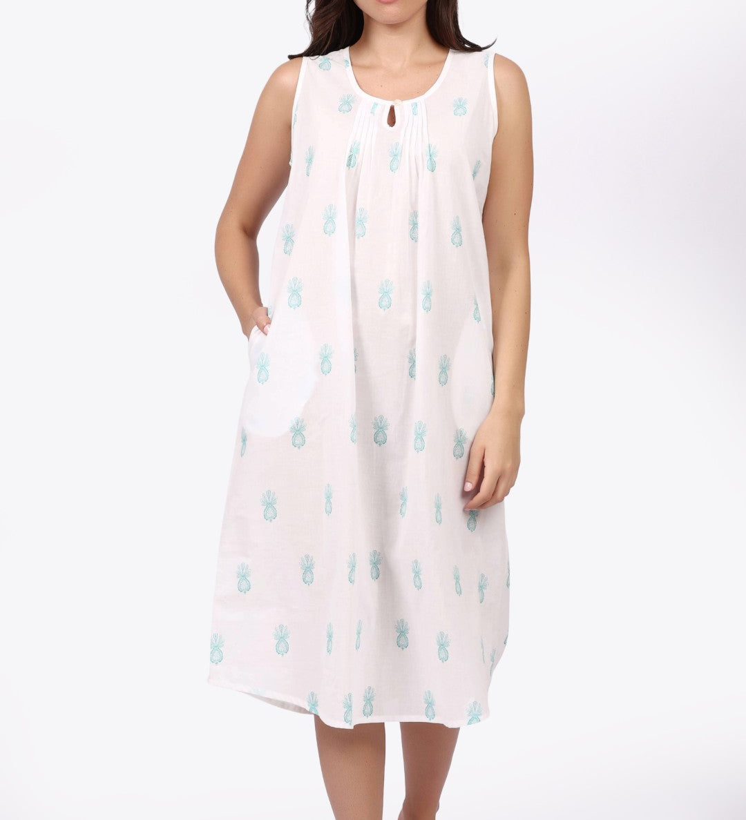 Woman wearing a sleeveless dress with a pattern on a white background