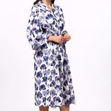 Woman wearing a floral patterned robe on a white background