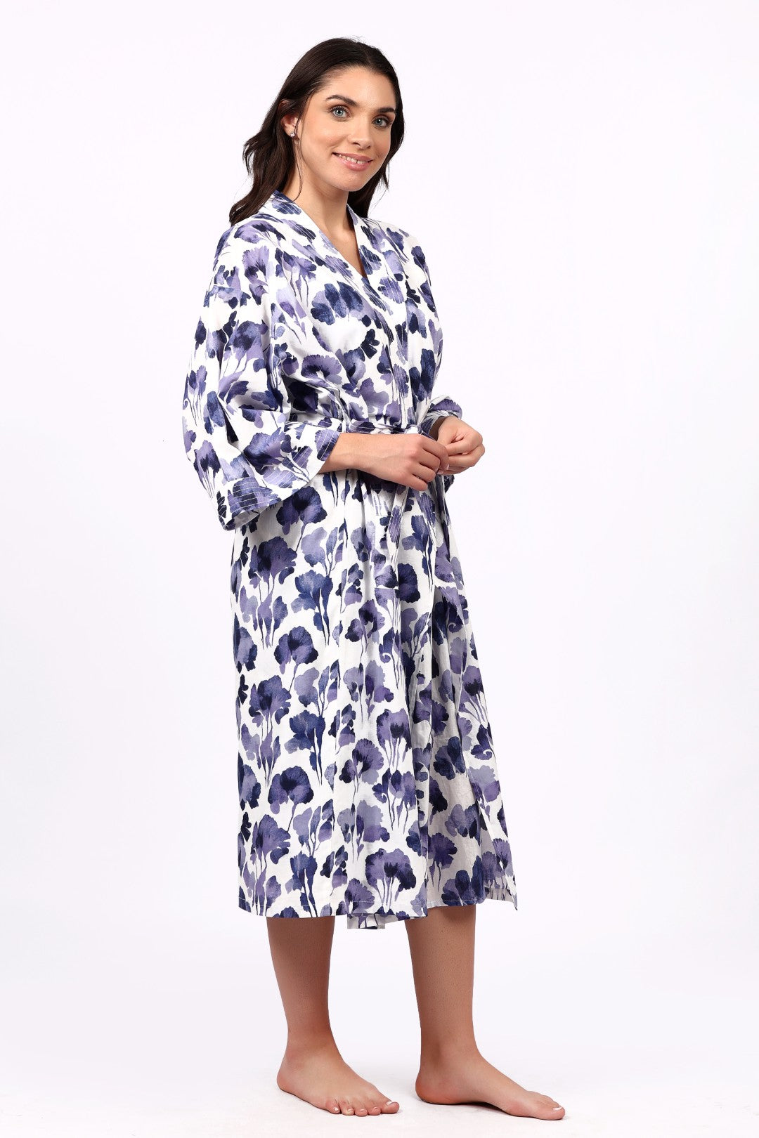 Woman wearing a floral patterned robe on a white background