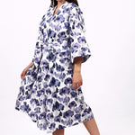 Woman wearing a floral patterned robe on a white background