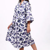 Woman wearing a floral patterned robe on a white background
