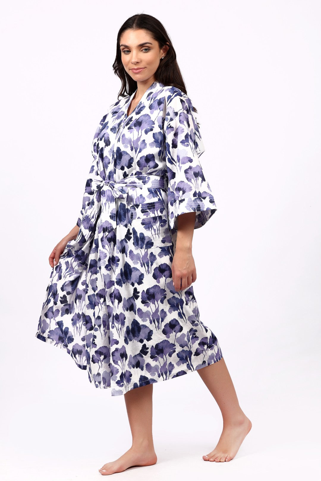 Woman wearing a floral patterned robe on a white background