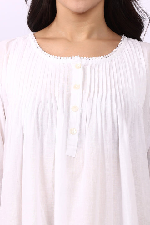 Close-up of pintuck detailing and buttoned neckline on Lotus Sara long sleeve cotton nightdress.