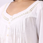 Close-up of pintuck bodice and lace-trim neckline on Lotus Susie cotton nightdress.