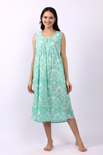 Woman wearing sleeveless cotton nightdress in spearmint green with Strawberry Thief print, keyhole neckline, and relaxed fit.