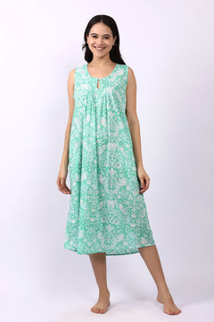 Woman wearing sleeveless cotton nightdress in spearmint green with Strawberry Thief print, keyhole neckline, and relaxed fit.