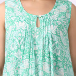 Woman wearing sleeveless cotton nightdress in spearmint green with Strawberry Thief print, keyhole neckline, and relaxed fit close up of pin tuck details.
