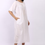 Side profile of Lotus Sara pintuck short sleeve white cotton nightdress with pocket detail.