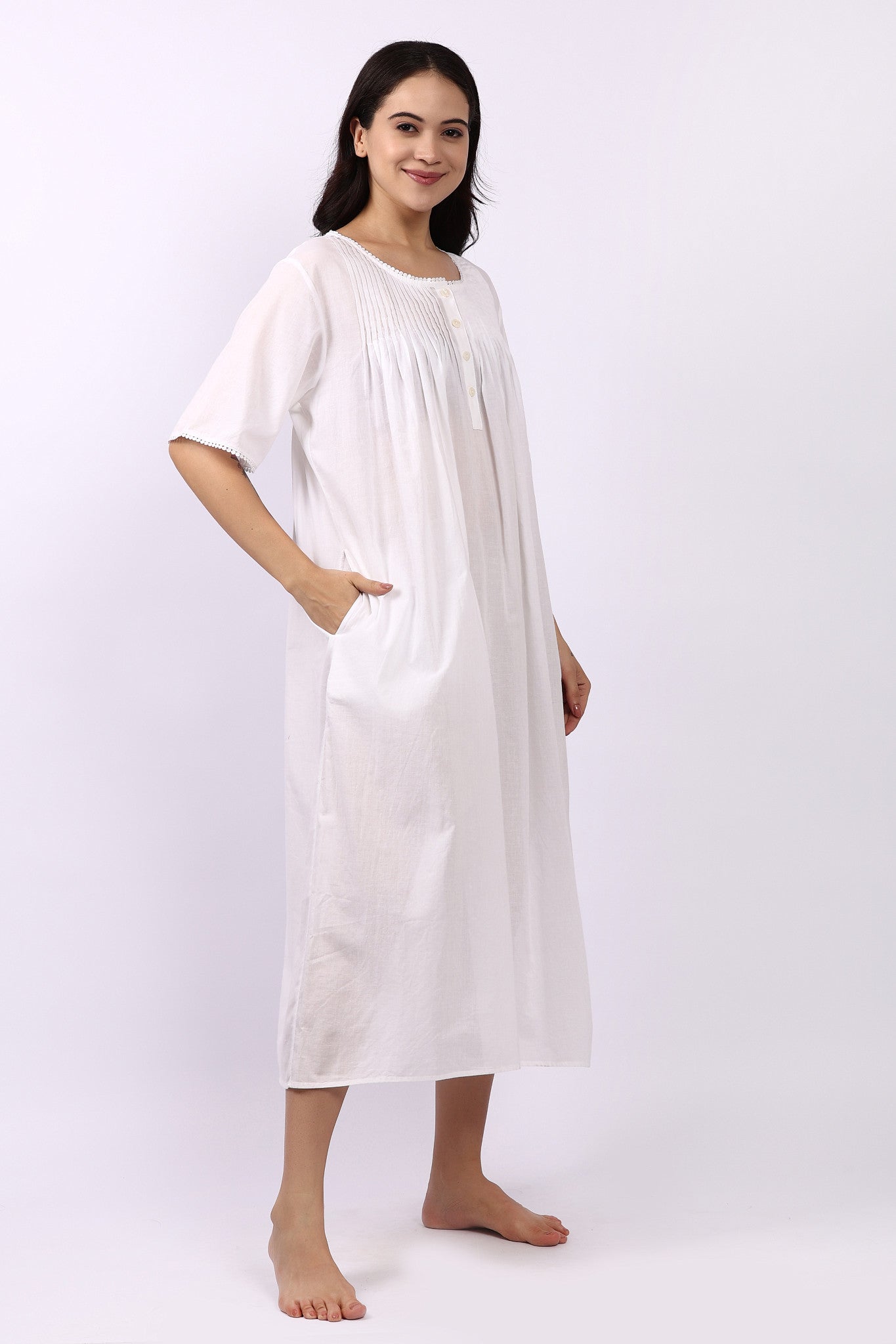 Side profile of Lotus Sara pintuck short sleeve white cotton nightdress with pocket detail.